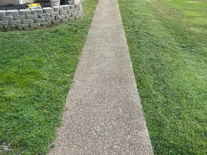 Crisp edged sidewalk after trimming service